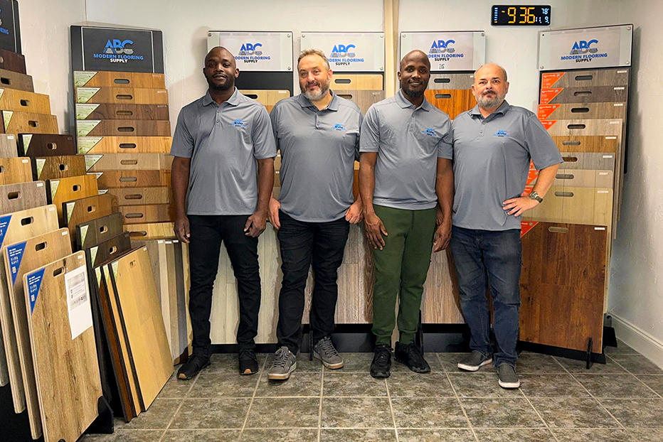 Team members at ABC Modern Flooring showroom surrounded by flooring samples